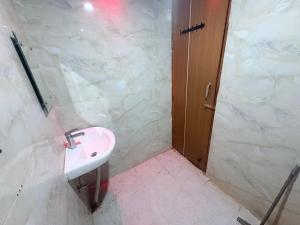 a bathroom with a sink and a shower at Hotel 69 in Gurgaon