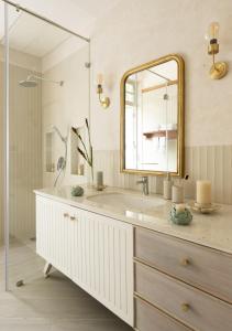 a bathroom with a sink and a mirror at LohonoStays Villa Floresta in Assagao
