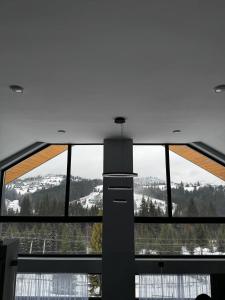 a large window in a building with a view at Cottages Grun in Yablunytsya