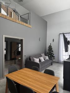 a living room with a couch and a christmas tree at Cottages Grun in Yablunytsya