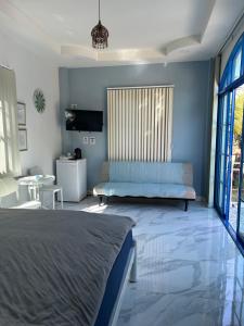 a bedroom with a bed and a couch at NAPA CHATEAU Resort in Ban San Khu