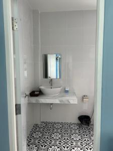 a white bathroom with a sink and a mirror at NAPA CHATEAU Resort in Ban San Khu