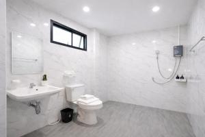 a white bathroom with a toilet and a sink at Soft Blue Home, Krabi Town in Krabi +10 photos