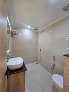 a bathroom with a sink and a toilet at Baba Palace in Ayodhya