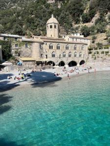 a group of people on a beach in front of a building at A Casa di Letta in Santa Margherita Ligure