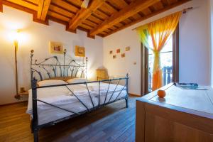 a bedroom with a bed and a large window at Platanus by Hotel Pieris in Pribylina