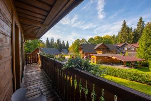 a balcony with a view of a house at Platanus by Hotel Pieris in Pribylina