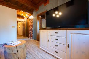 a large tv on top of a dresser in a room at Platanus by Hotel Pieris in Pribylina