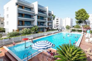 a swimming pool in front of a building at Hotel La Villa in Martinsicuro