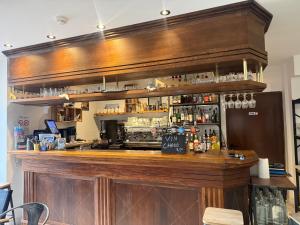 a bar in a restaurant with a counter top at Le Touring in Isola