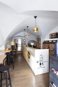 a kitchen with a counter and some tables and chairs at Hotel 100 in Pardubice