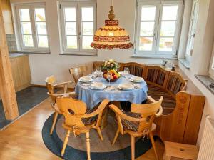 a dining room with a blue table and chairs at Bergperle am Lindberg in Perlesreut