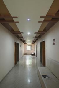 an empty corridor of an office building with a long hallway at Greenland Resort in Silvassa