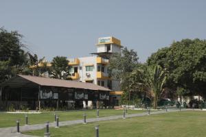 a large building in the middle of a park at Greenland Resort in Silvassa