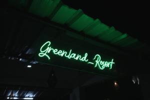 a neon sign that says greenland resort in the dark at Greenland Resort in Silvassa