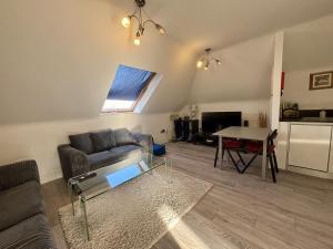 a living room with a couch and a table at Egham Modern Two Bedroom Apartment in Egham