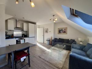 a living room with a couch and a table at Egham Modern Two Bedroom Apartment in Egham