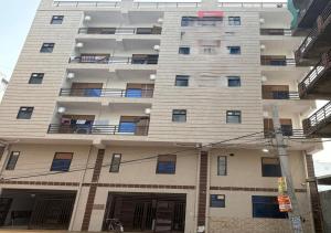 a tall apartment building with its doors open at Hotel 69 in Gurgaon