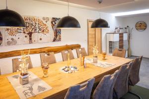a dining room with a long wooden table and chairs at Traumferienhaus XXL Ortner in Wetzendorf