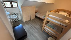 a small room with two bunk beds and a bathroom at Aupalya Gîte Le Logis Catalan in Font-Romeu +2 photos