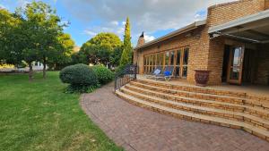 a brick house with a porch and a patio at Grobler's Haven On Vaal - Barrage in Tumahole