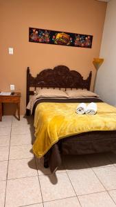 a bedroom with a bed with two towels on it at Templo de la Luna Pardo in Cusco
