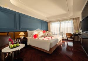 a bedroom with a large bed with fruit on it at Diana Cruises Halong Bay - Luxury by Venus Group in Ha Long