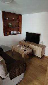 a living room with a flat screen tv and a couch at Bernal I, II y III in Los Sauces +60 photos