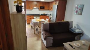 a kitchen with a table and a couch in a kitchen at Bernal I, II y III in Los Sauces