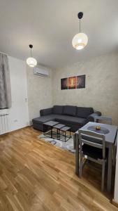 a living room with a couch and a table at Apartman Simić in Smederevo