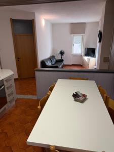a white table in a room with a living room at 1Dest - Lake & Family in Riva del Garda