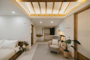 a living room with a couch and a chair at Bow Hanok House in Gangneung