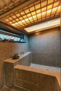 a bathroom with a large shower with a sink at Bow Hanok House in Gangneung