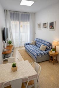a living room with a couch and a table at RelaxMaria in Sant Carles de la Ràpita