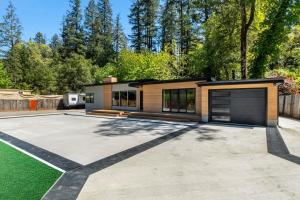 a house with a driveway and a garage at Redwoods Luxury Sanctuary in Redway