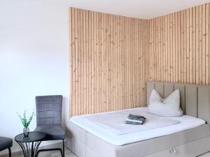 a bedroom with a bed with a chair and a table at Ferienwohnung Perle im Grünen - Urlaub an der Müritz in Federow