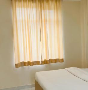 a bedroom with two beds and a window at Udaigarh Palace - The Heritage Hotel in Jodhpur