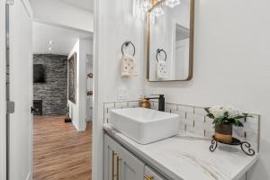 a white bathroom with a sink and a mirror at Redwoods Luxury Sanctuary in Redway +17 photos