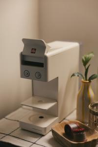a printer sitting on top of a counter with a mouse at Bow Hanok House in Gangneung +16 photos