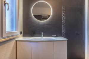 a bathroom with a sink and a mirror at Katrina's Home alloggio turistico in Fiumicino +19 photos