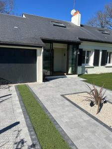 a house with a driveway and a garage at A Orléans proche orée de sologne in Orléans