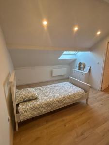 a bedroom with a bed and a skylight at A Orléans proche orée de sologne in Orléans