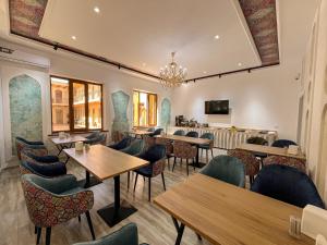a restaurant with tables and chairs and a bar at AYUB Modern & Heritage HOTEL in Bukhara