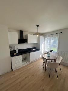 a kitchen with a table and a table and chairs at A Orléans proche orée de sologne in Orléans