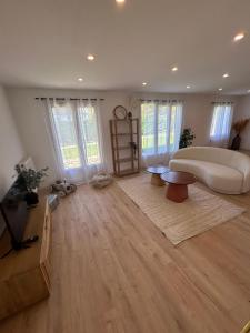a large living room with a couch and a table at A Orléans proche orée de sologne in Orléans