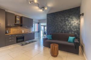 a living room with a couch and a table at Katrina's Home alloggio turistico in Fiumicino