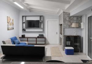 a living room with a couch and a fireplace at At last in Pearly Beach