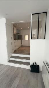 a living room with stairs and a black purse at large downtown studio in Corbeil-Essonnes