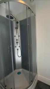 a shower with a glass enclosure in a bathroom at large downtown studio in Corbeil-Essonnes