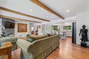 a living room with a couch and a kitchen at Redwoods Luxury Sanctuary in Redway